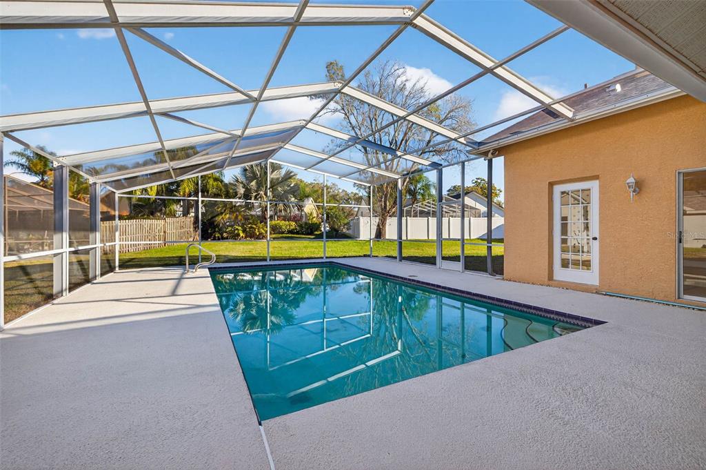 1819 Tree Swallow Way Palm Harbor, FL 34683 - Photo 32 of 39 a view of a swimming pool with a patio