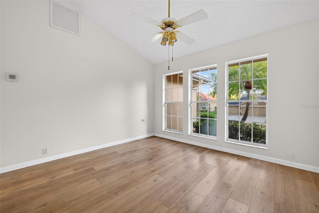 1819 Tree Swallow Way Palm Harbor, FL 34683 - Photo 5 of 39 a view of an empty room with a window and wooden floor