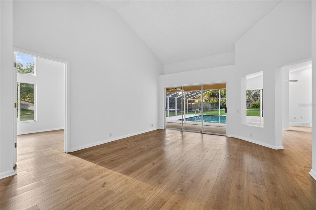 1819 Tree Swallow Way Palm Harbor, FL 34683 - Photo 6 of 39 a view of an empty room with wooden floor and a window