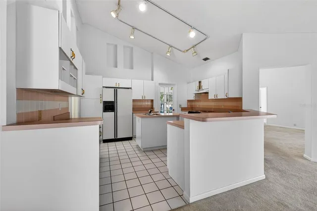 a kitchen with cabinets and a stove top oven