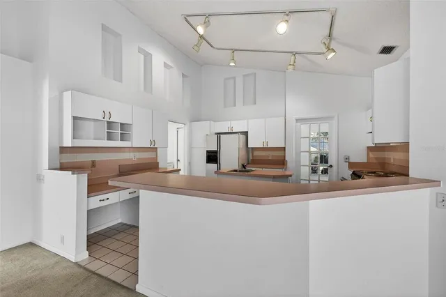 a kitchen with stainless steel appliances a sink and a refrigerator