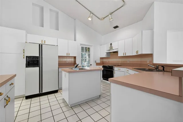 a kitchen with cabinets and stainless steel appliances