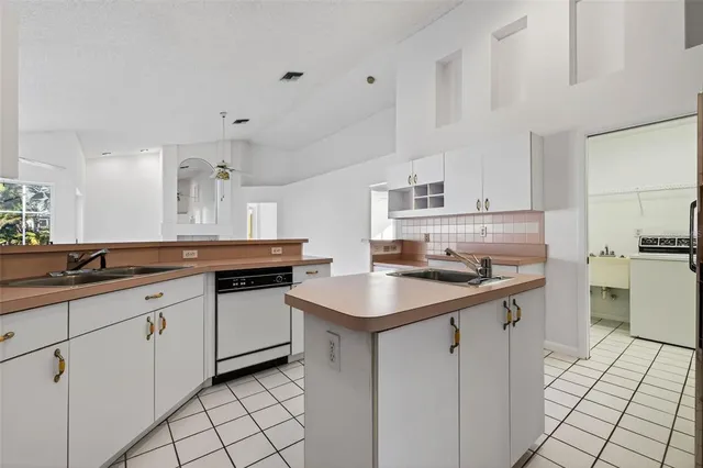 a kitchen with a sink stove and cabinets