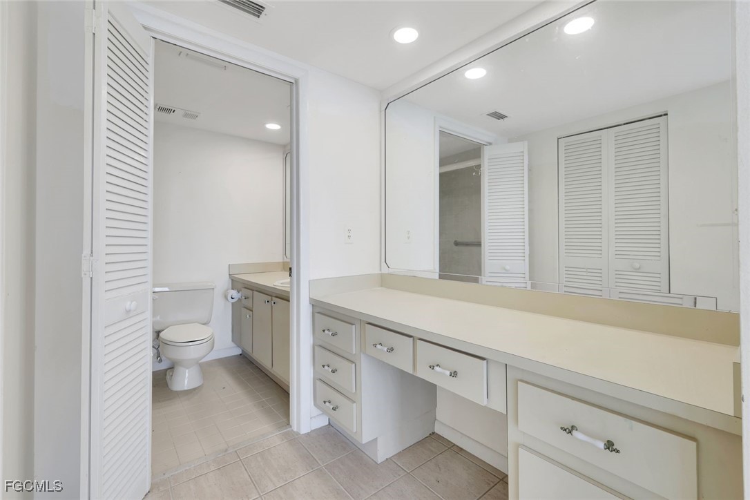 15010 Punta Rassa Road, Unit 305 Fort Myers, FL 33908 - Photo 15 of 21 a bathroom with a toilet a sink and mirror