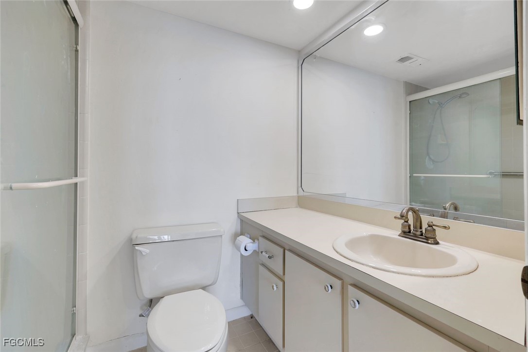 15010 Punta Rassa Road, Unit 305 Fort Myers, FL 33908 - Photo 16 of 21 a bathroom with a sink toilet and a mirror