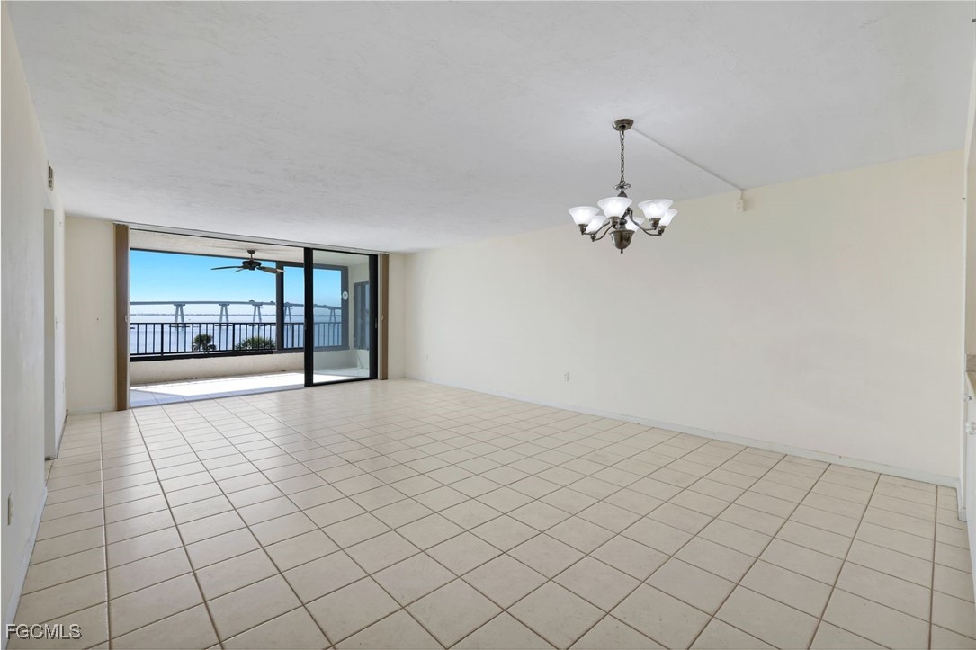 15010 Punta Rassa Road, Unit 305 Fort Myers, FL 33908 - Photo 6 of 21 a view of an empty room with a chandelier