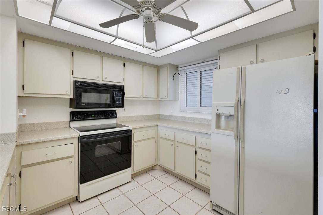 15010 Punta Rassa Road, Unit 305 Fort Myers, FL 33908 - Photo 8 of 21 a kitchen with cabinets stainless steel appliances and sink
