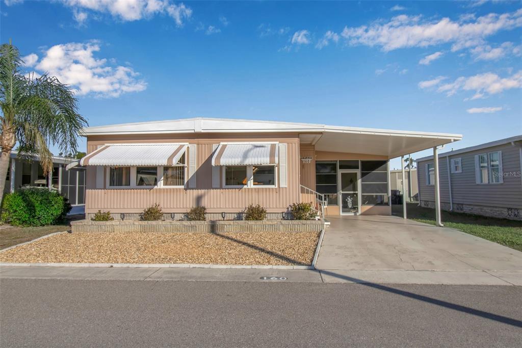 5619 Bayshore Road, Unit 160 Palmetto, FL 34221 - Photo 1 of 30 a front view of a house with a yard and potted plants
