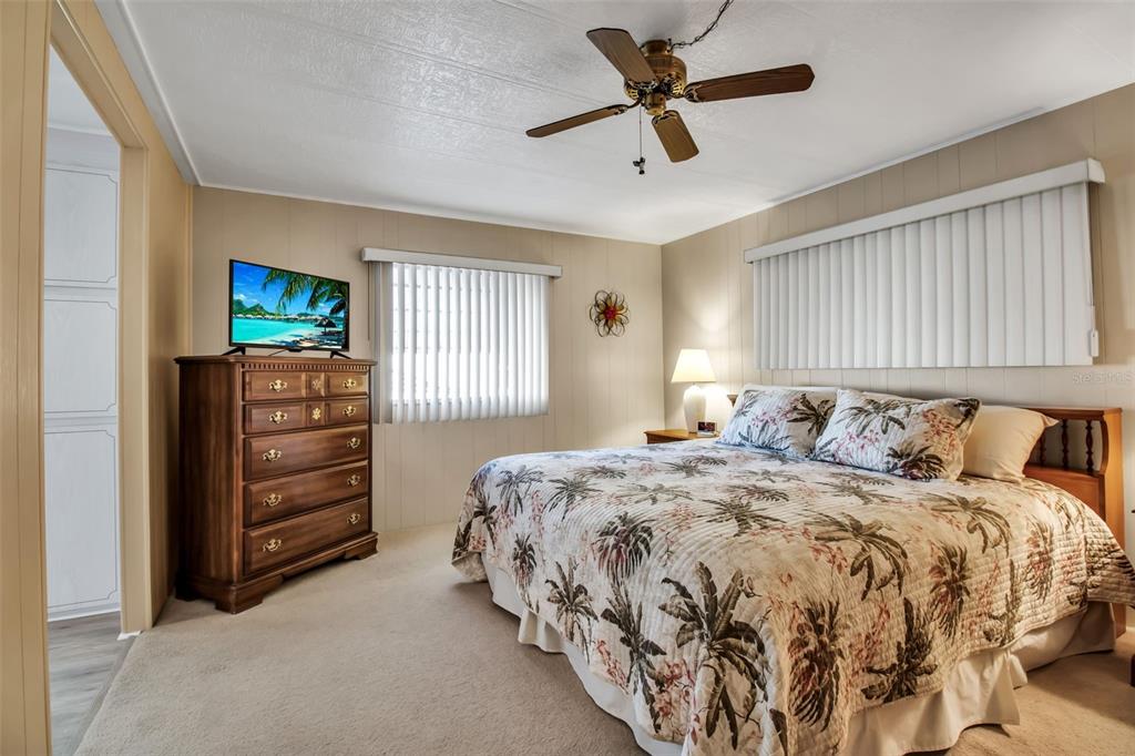 5619 Bayshore Road, Unit 160 Palmetto, FL 34221 - Photo 12 of 30 a bedroom with a bed a dresser and a flat screen tv