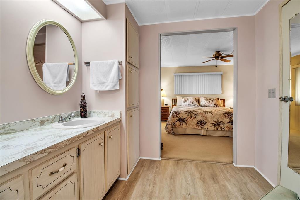 5619 Bayshore Road, Unit 160 Palmetto, FL 34221 - Photo 15 of 30 a en suite bathroom with a granite countertop sink and a mirror