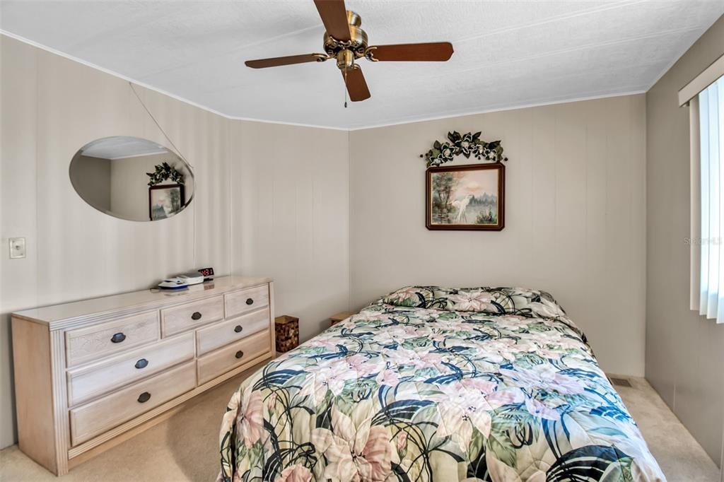 5619 Bayshore Road, Unit 160 Palmetto, FL 34221 - Photo 19 of 30 a bedroom with a bed and a dresser