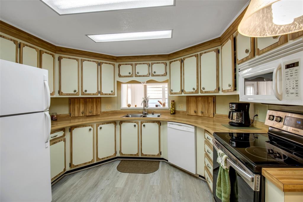 5619 Bayshore Road, Unit 160 Palmetto, FL 34221 - Photo 2 of 30 a kitchen with stainless steel appliances granite countertop a stove a sink dishwasher and a refrigerator