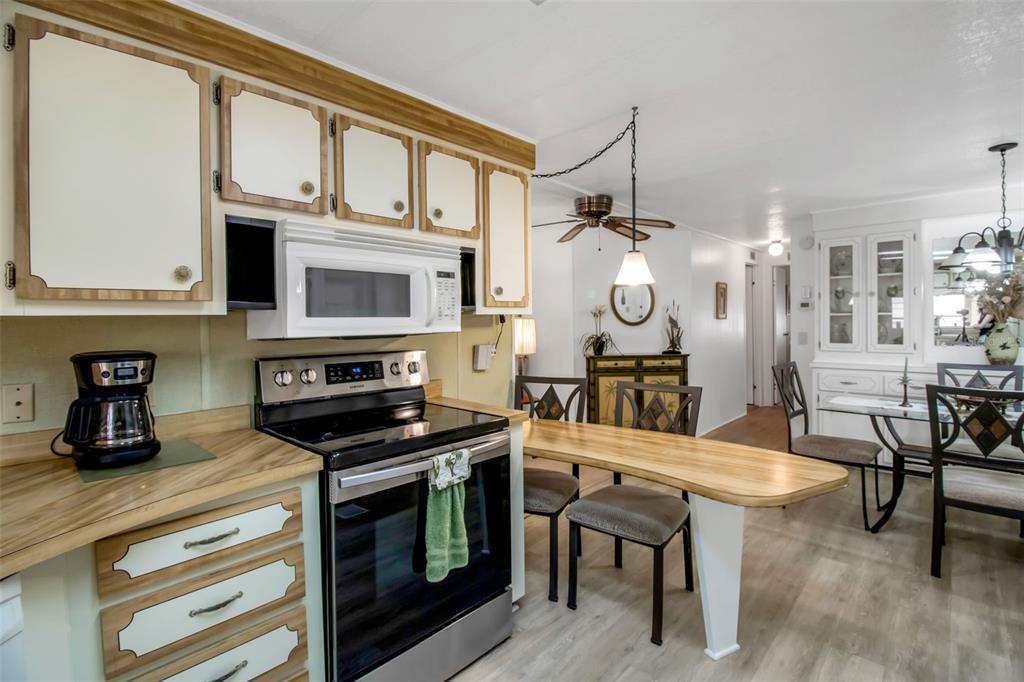 5619 Bayshore Road, Unit 160 Palmetto, FL 34221 - Photo 3 of 30 a kitchen with stainless steel appliances granite countertop a stove a sink and a white cabinets