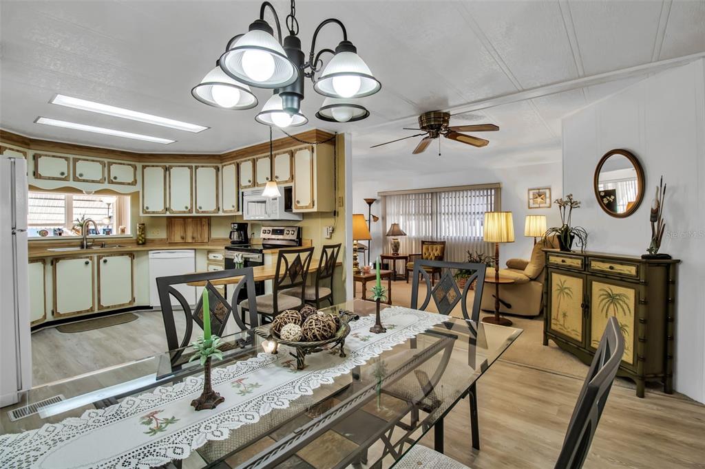 5619 Bayshore Road, Unit 160 Palmetto, FL 34221 - Photo 6 of 30 a view of a dining room with furniture a kitchen and chandelier