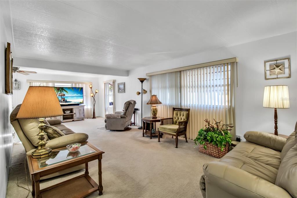 5619 Bayshore Road, Unit 160 Palmetto, FL 34221 - Photo 7 of 30 a living room with furniture and a lamp