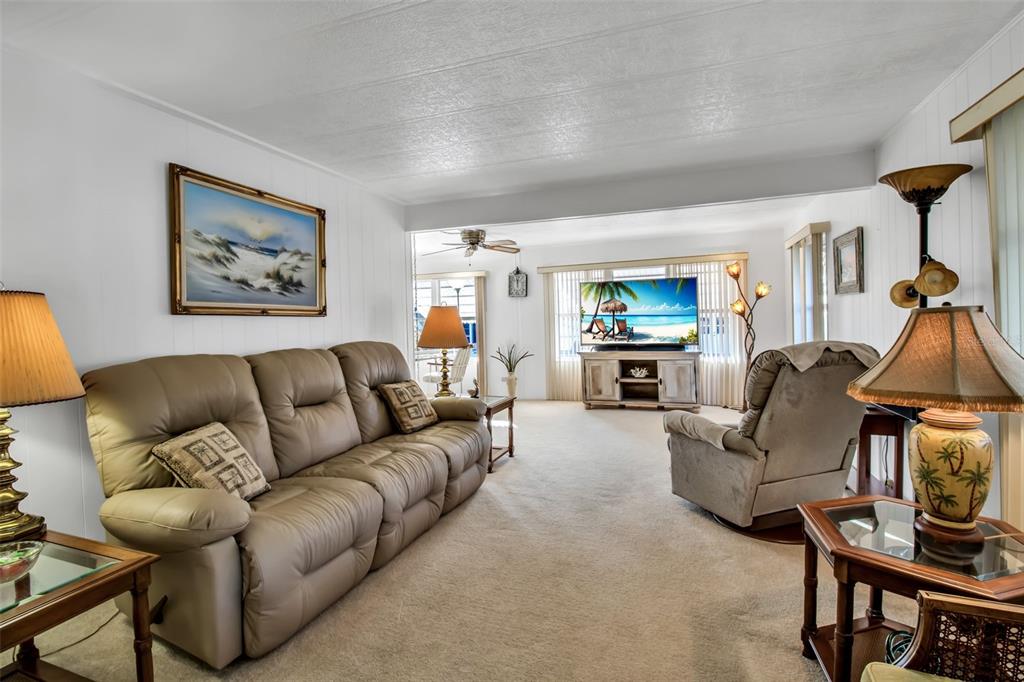 5619 Bayshore Road, Unit 160 Palmetto, FL 34221 - Photo 8 of 30 a living room with furniture and a flat screen tv