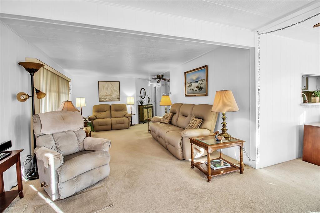 5619 Bayshore Road, Unit 160 Palmetto, FL 34221 - Photo 9 of 30 a living room with furniture and a lamp