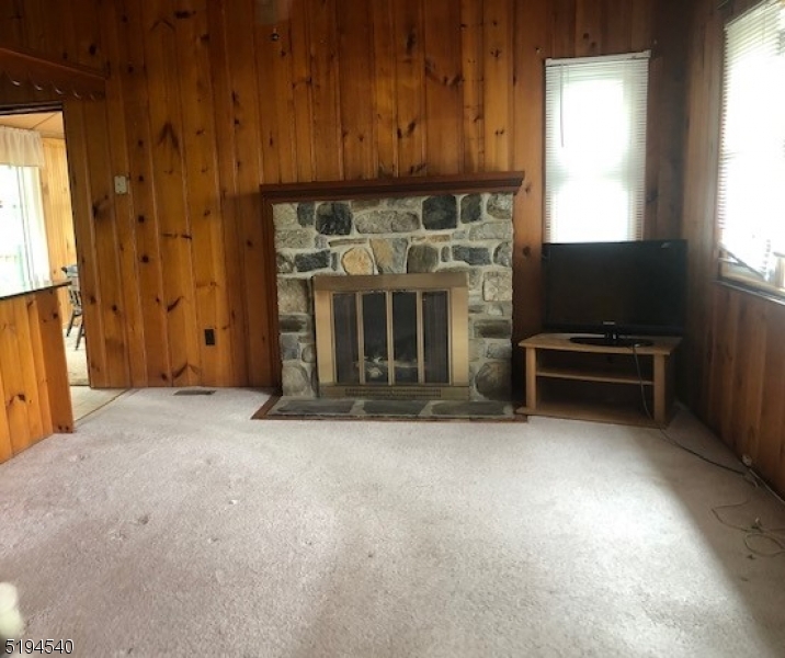 208 Pohatcong Road Vernon, NJ 07422 - Photo 2 of 15 a view of a livingroom with furniture and a fireplace