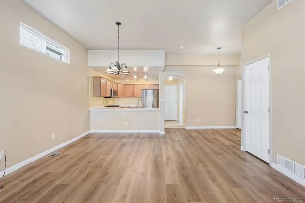 a view of a kitchen with wooden floor and windows