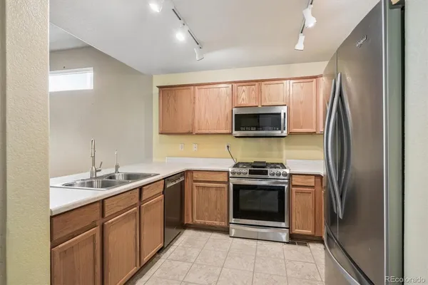 a kitchen with a sink stove and refrigerator