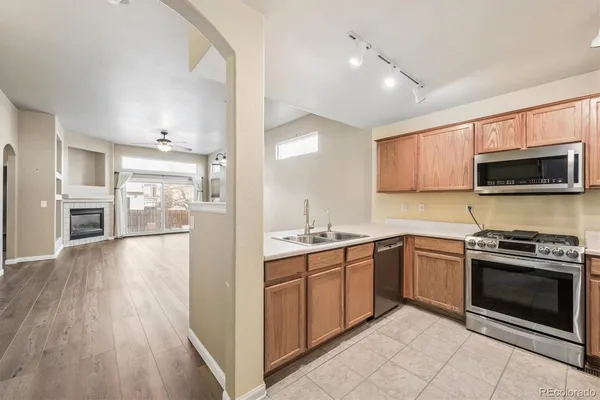 a kitchen with a sink stove and refrigerator