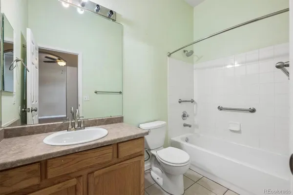 a bathroom with a granite countertop sink toilet a mirror and shower