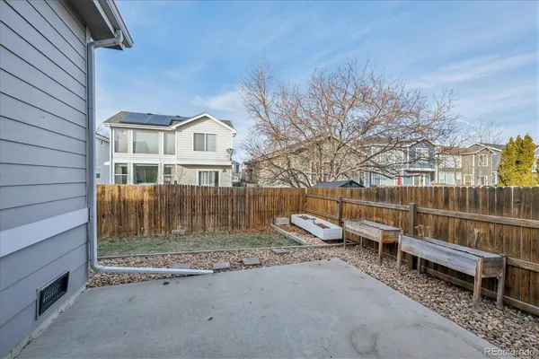 a view of a house with a wooden deck and a backyard