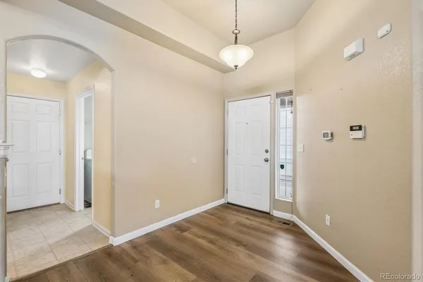 an empty room with closet and a chandelier fan