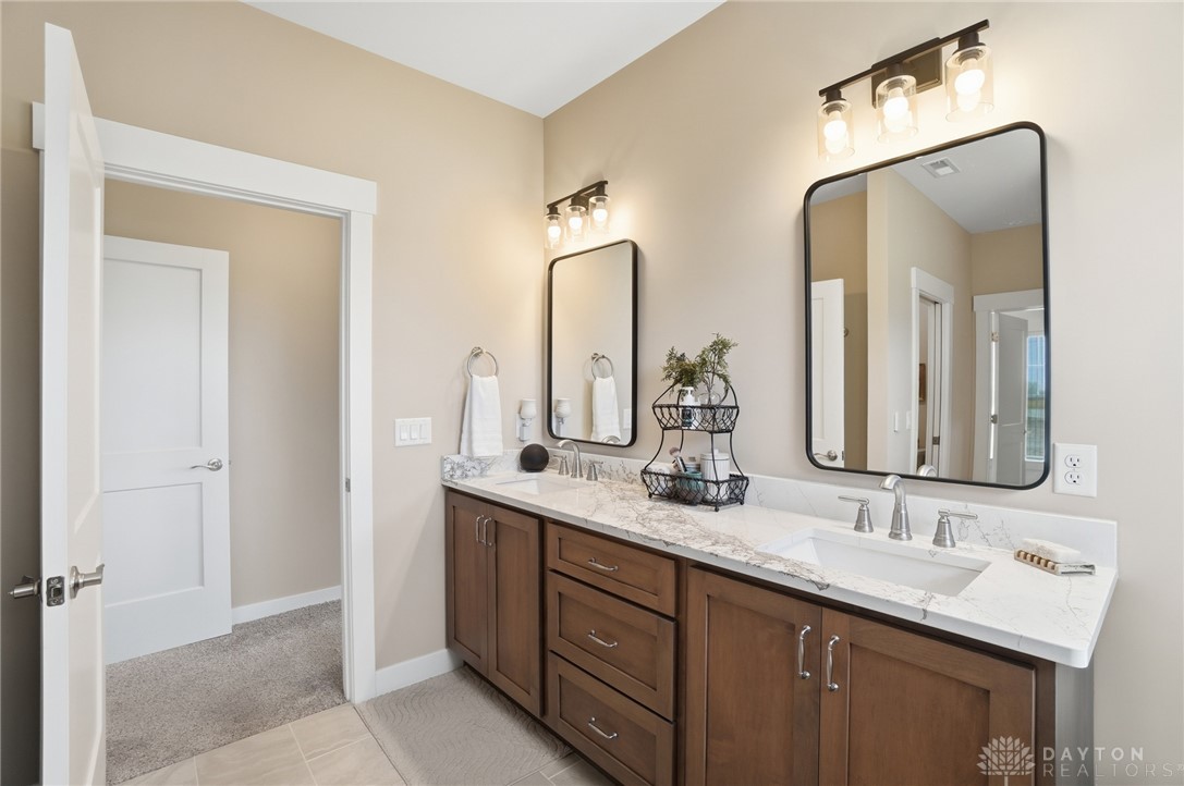 9364 Kenrick Road Dayton, OH 45458 - Photo 24 of 62 This spacious bathroom offers elegant dual vanities and bright lighting, perfect for any morning routine.