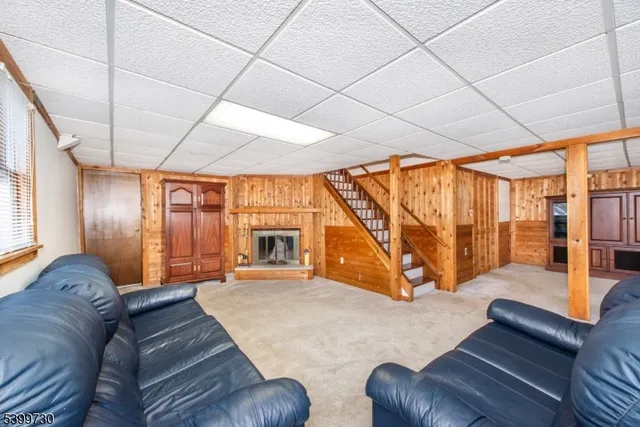 a living room with furniture a large window with outer view