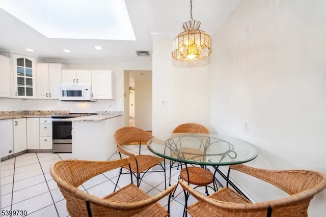 a view of a dining room with furniture and chandelier