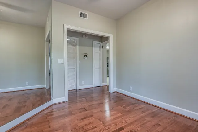 a kitchen with stainless steel appliances granite countertop a stove top oven a sink dishwasher and a microwave oven with wooden floor