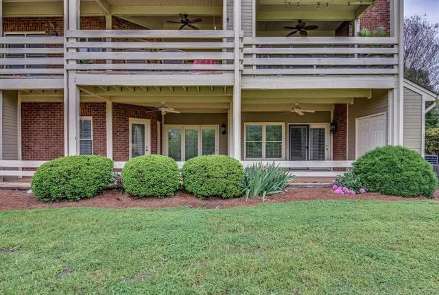 a view of a porch with a floor to ceiling window and wooden floor