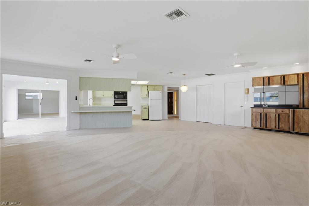 135 Pebble Beach Boulevard Naples, FL 34113 - Photo 12 of 37 a view of a kitchen with refrigerator and a kitchen