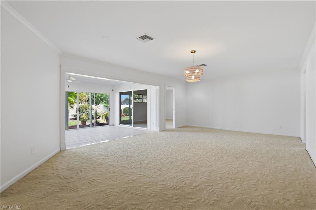 135 Pebble Beach Boulevard Naples, FL 34113 - Photo 14 of 37 en empty room with windows and cabinet