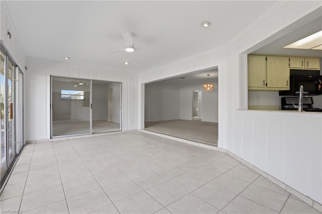 135 Pebble Beach Boulevard Naples, FL 34113 - Photo 16 of 37 a view of livingroom with furniture and a flat screen tv