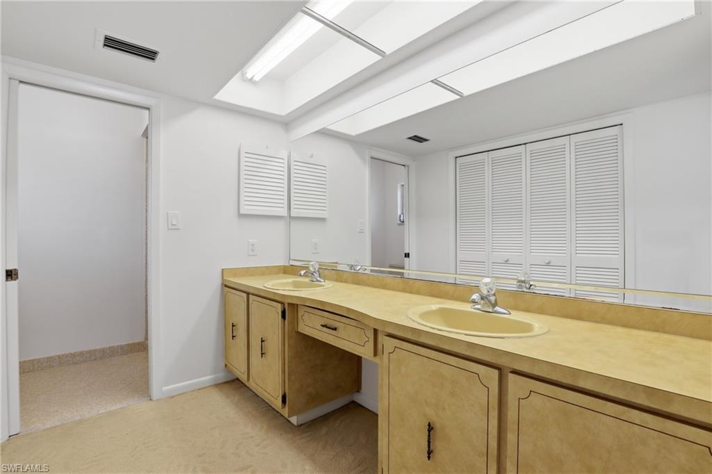 135 Pebble Beach Boulevard Naples, FL 34113 - Photo 18 of 37 a bathroom with a sink and a tub