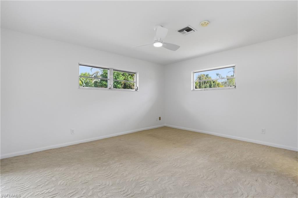 135 Pebble Beach Boulevard Naples, FL 34113 - Photo 20 of 37 an empty room with windows