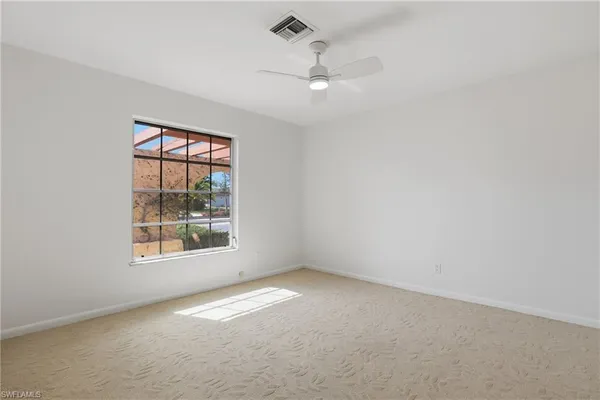 an empty room with window and pillar in it