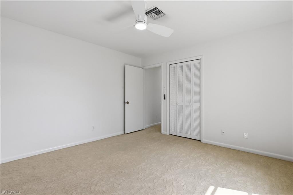 135 Pebble Beach Boulevard Naples, FL 34113 - Photo 24 of 37 an empty room with chandelier fan