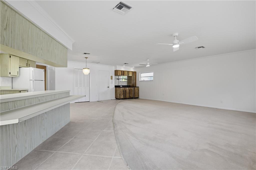 135 Pebble Beach Boulevard Naples, FL 34113 - Photo 26 of 37 a view of a kitchen with a dishwasher and a refrigerator
