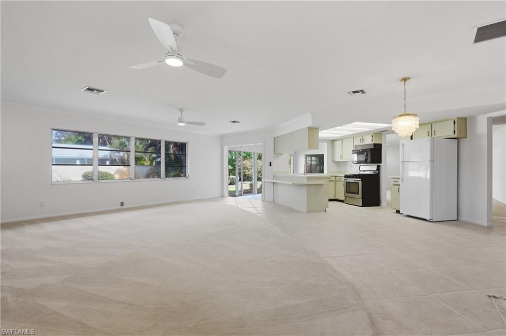135 Pebble Beach Boulevard Naples, FL 34113 - Photo 30 of 37 a view of a kitchen with refrigerator and windows