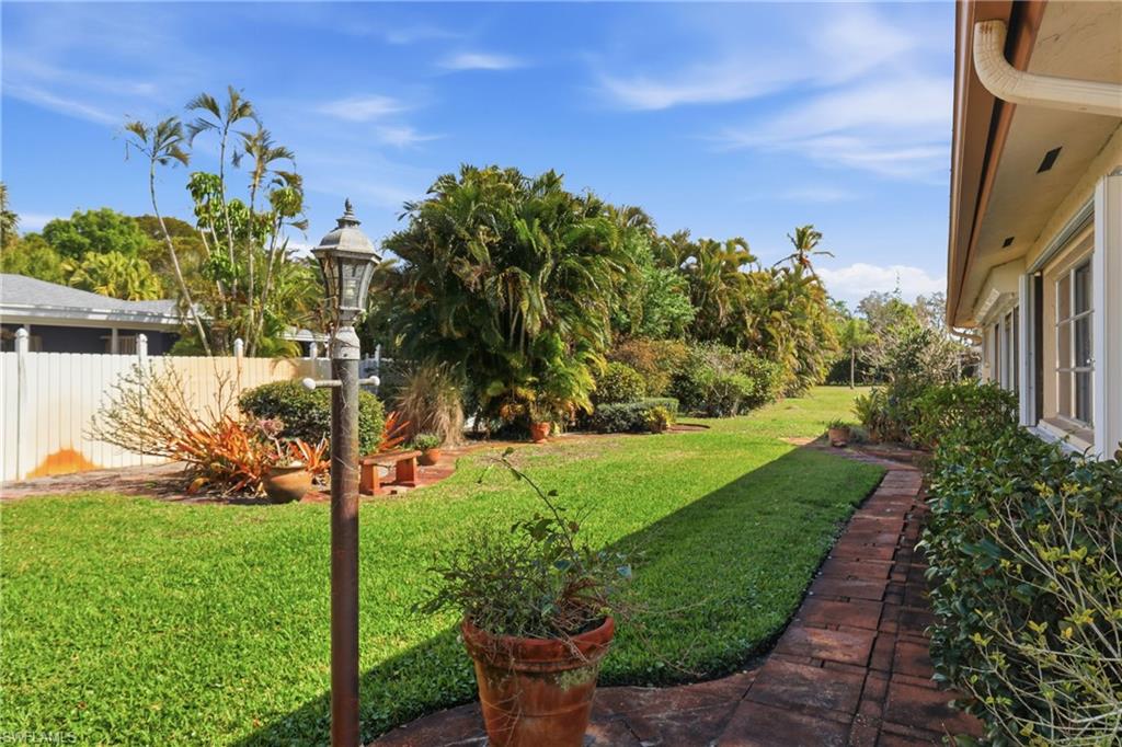 135 Pebble Beach Boulevard Naples, FL 34113 - Photo 35 of 37 a view of a backyard with pathway