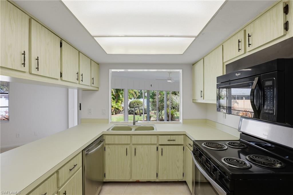135 Pebble Beach Boulevard Naples, FL 34113 - Photo 6 of 37 a kitchen with granite countertop a stove and a sink