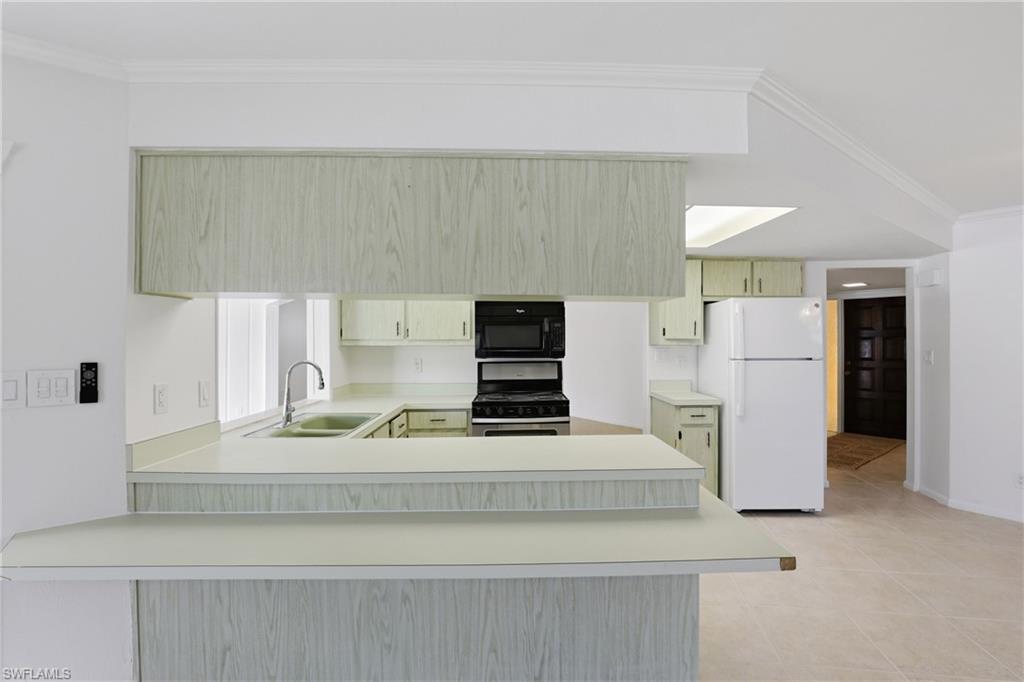 135 Pebble Beach Boulevard Naples, FL 34113 - Photo 7 of 37 a view of kitchen with stainless steel appliances granite countertop refrigerator sink and stove
