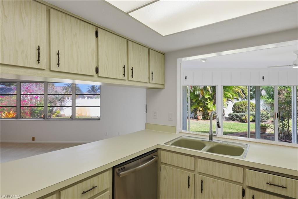 135 Pebble Beach Boulevard Naples, FL 34113 - Photo 8 of 37 a kitchen with a sink and cabinets
