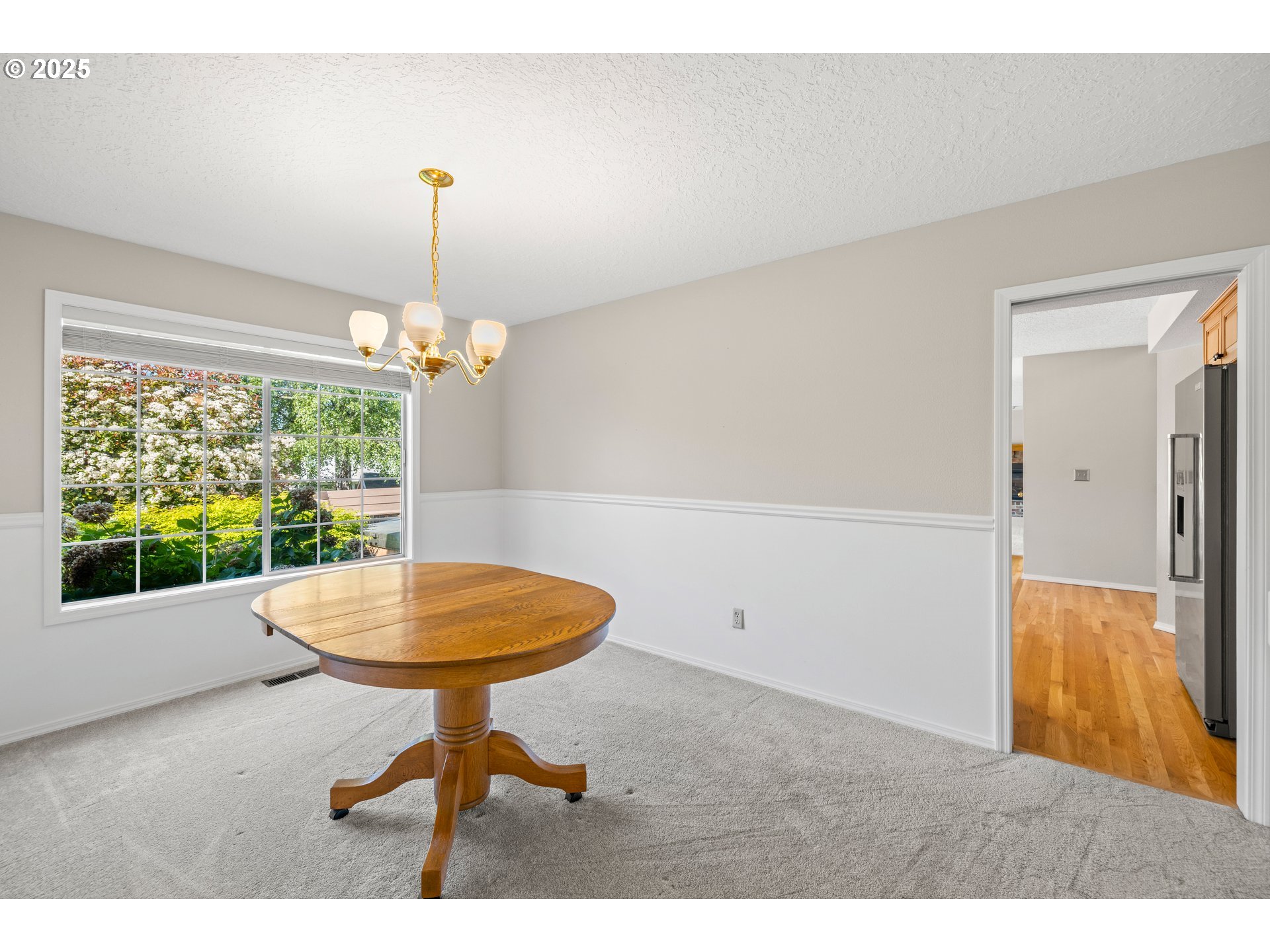 5393 Southwest Wichita Street Tualatin, OR 97062 - Photo 12 of 45 a living room with a table and a chandelier