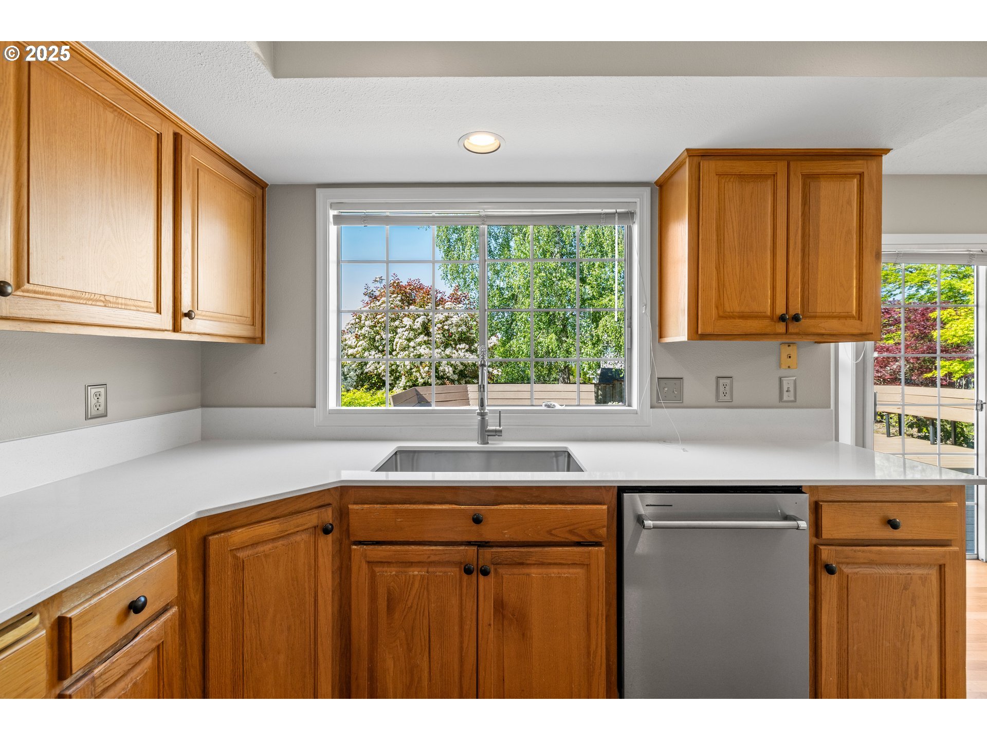 5393 Southwest Wichita Street Tualatin, OR 97062 - Photo 16 of 45 a kitchen with kitchen island granite countertop a sink cabinets and window