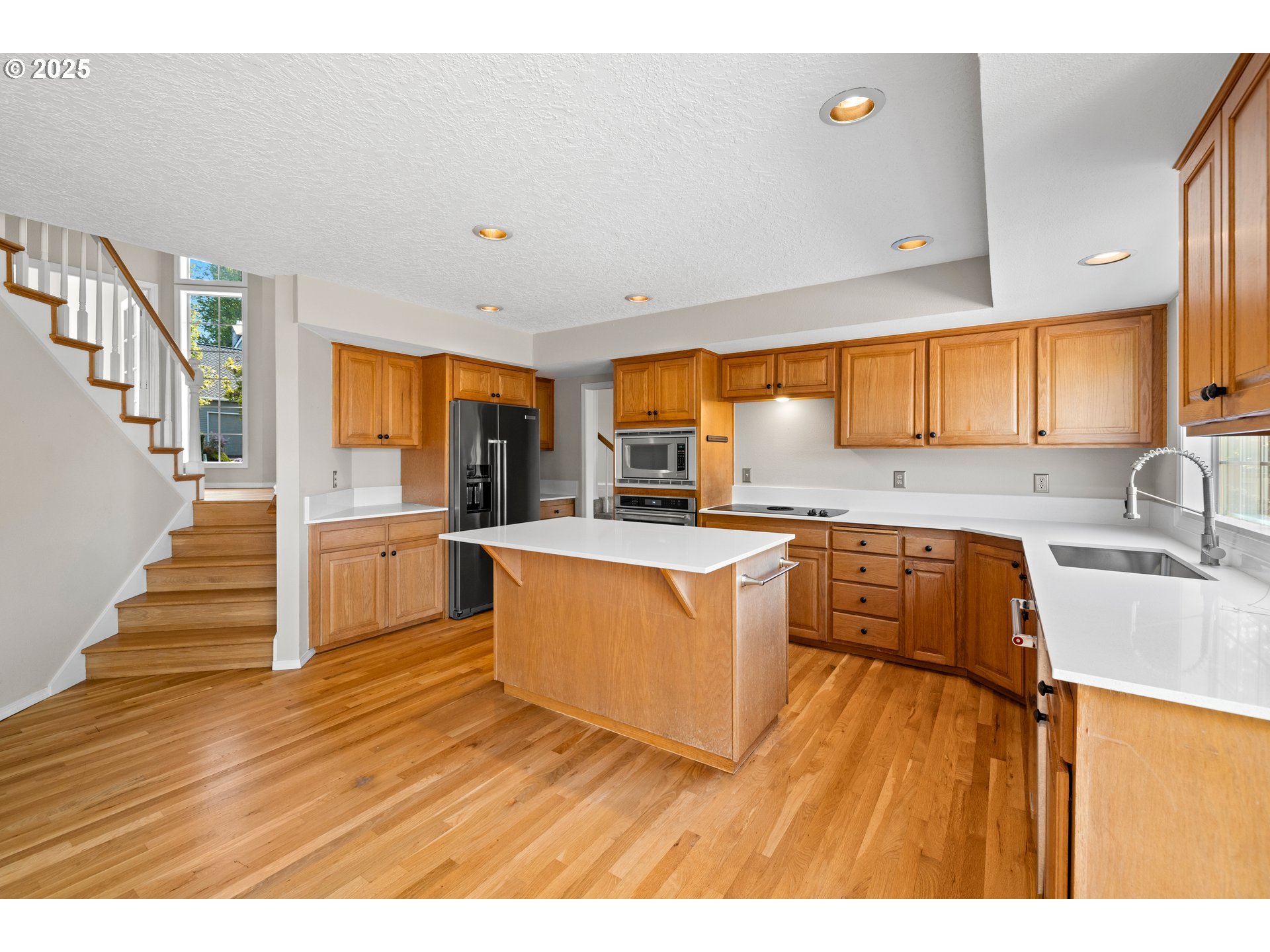 5393 Southwest Wichita Street Tualatin, OR 97062 - Photo 19 of 45 a kitchen with wooden floors and a sink