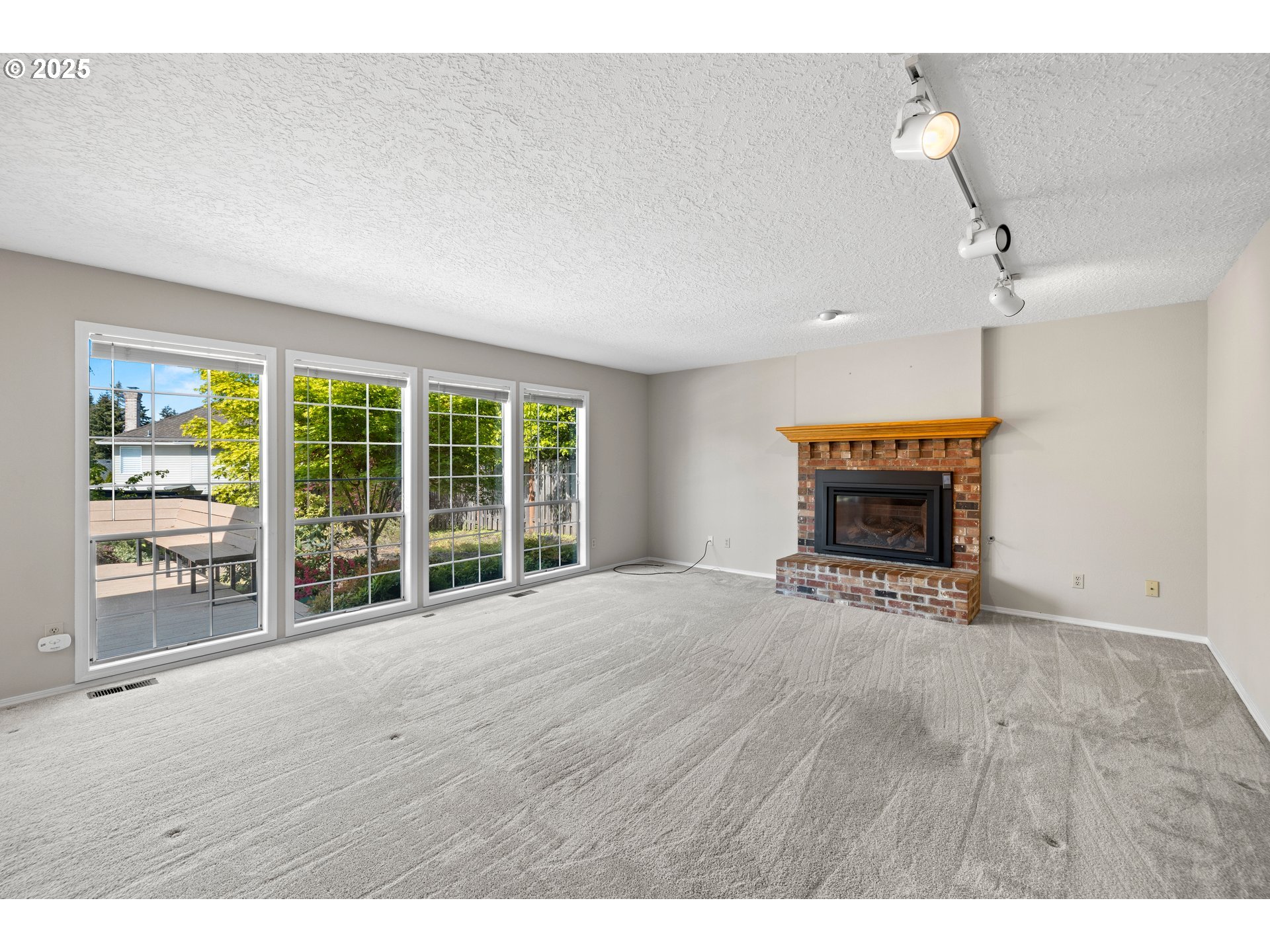 5393 Southwest Wichita Street Tualatin, OR 97062 - Photo 20 of 45 a view of an empty room with wooden floor and a window